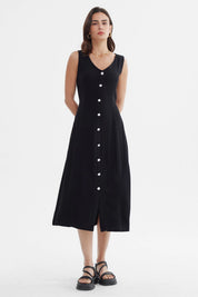 Vestido negro sin mangas con botones blancos al frente estilo minimalista diseño ajustable liso