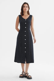 Vestido negro sin mangas con botones blancos al frente y diseño de lunares pequeños blancos