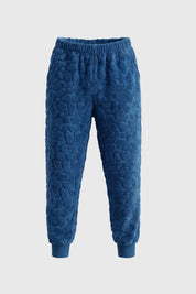 Pijama de niño azul con capucha de dinosaurio y bolsillo celeste diseño escamas en toda la prenda estilo divertido