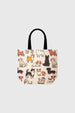 Bolsa grande blanca con estampado de perros en estilo caricatura de colores diversos sobre fondo claro sin texto visible