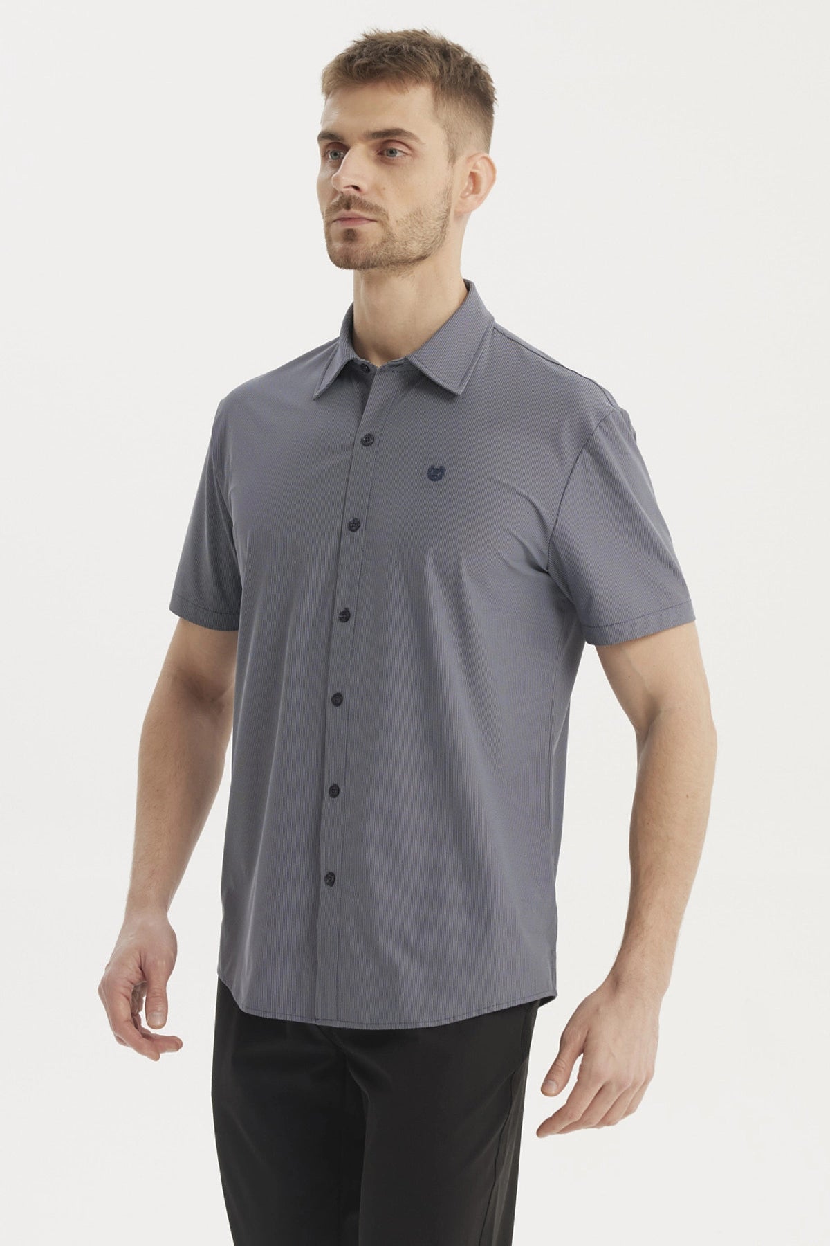 Camisa hombre slim azul marino de manga corta lisa con cuello camisero y botón frontal pequeño logo en el pecho izquierdo