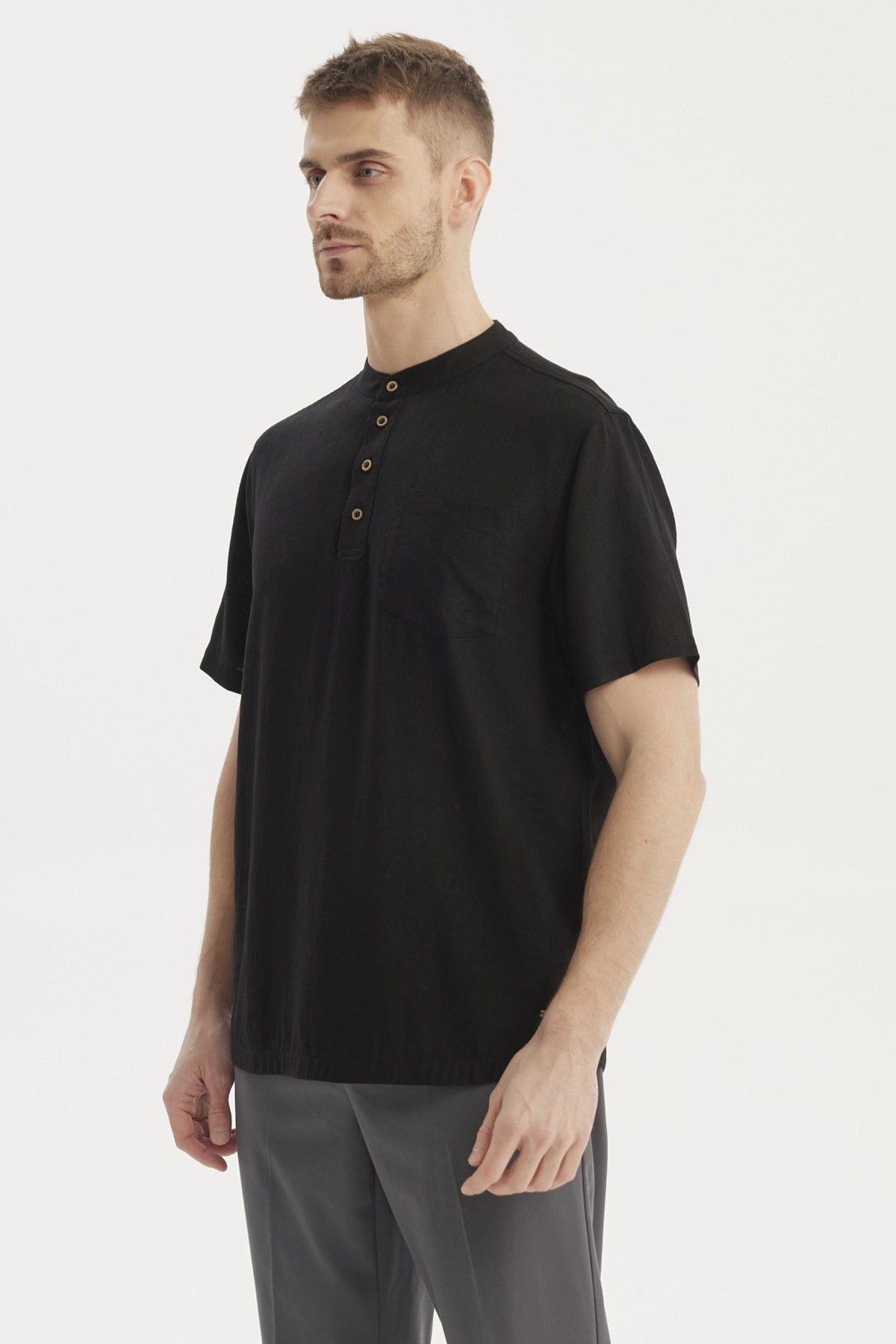 Camisa negra hombre manga corta con botones de madera en fila central y bolsillo liso en el pecho