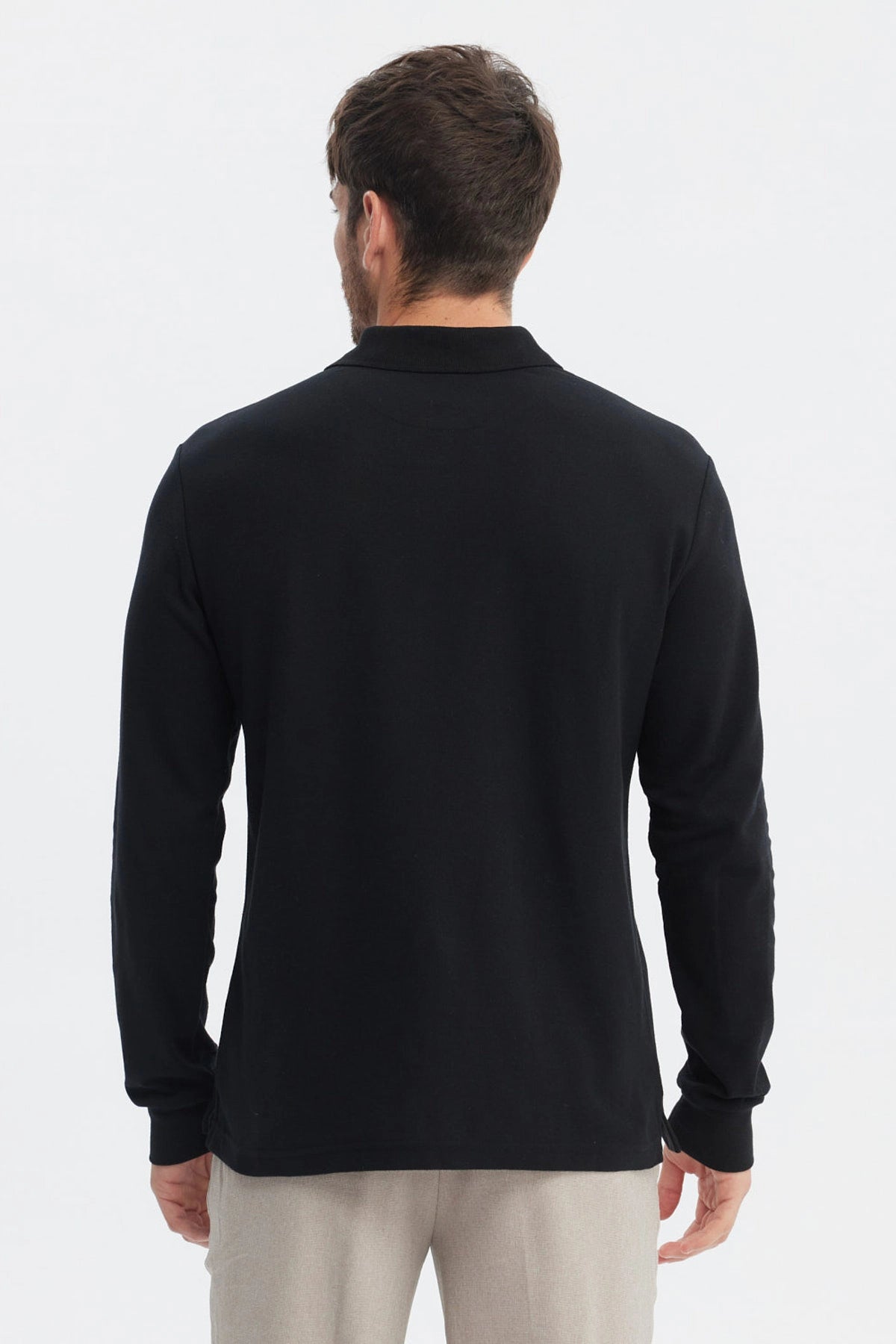 Polera negra lisa de manga larga con cuello polo y botones al frente