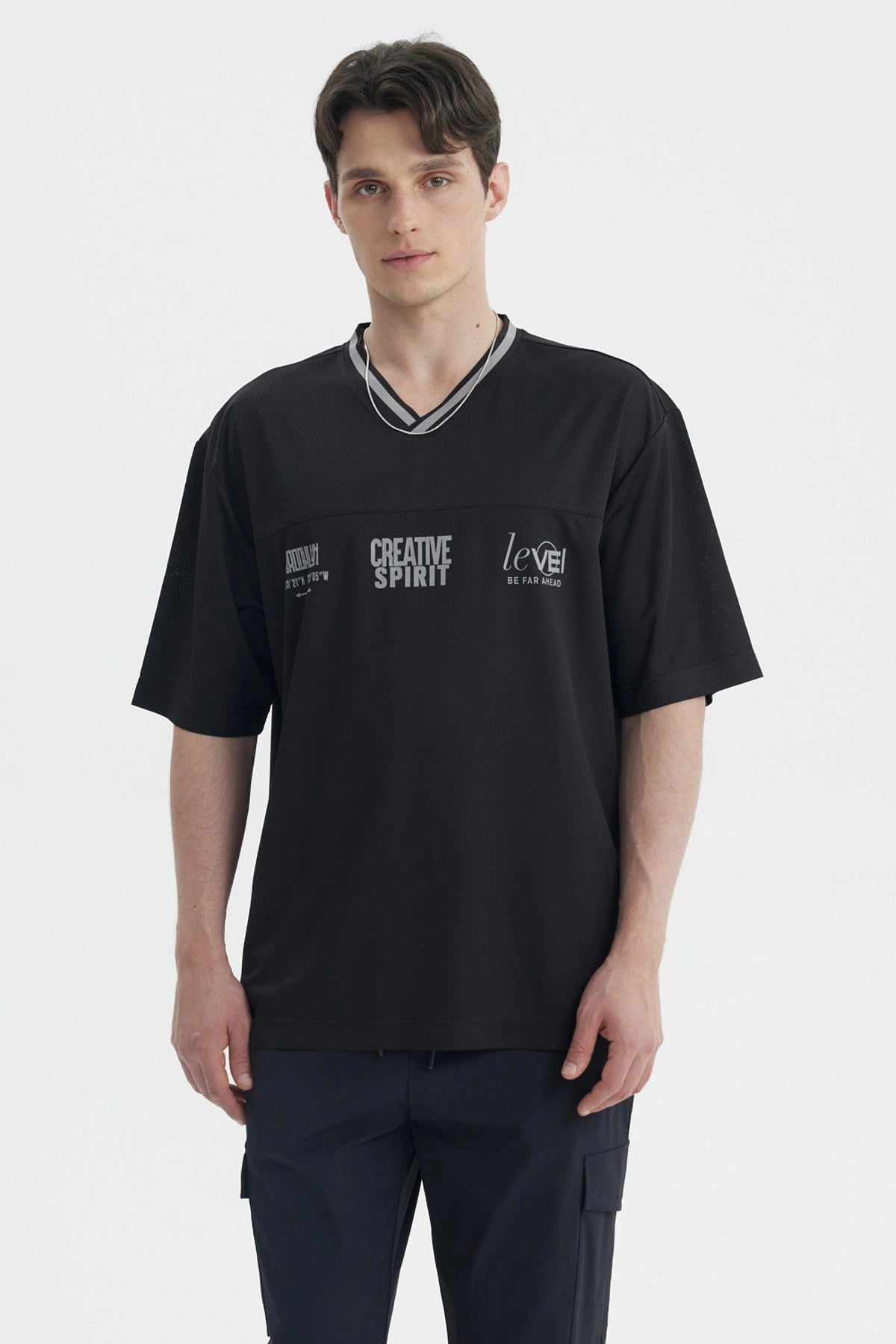 Polera hombre negra de corte slim con cuello en V y texto creativo en el pecho estilo casual moderno