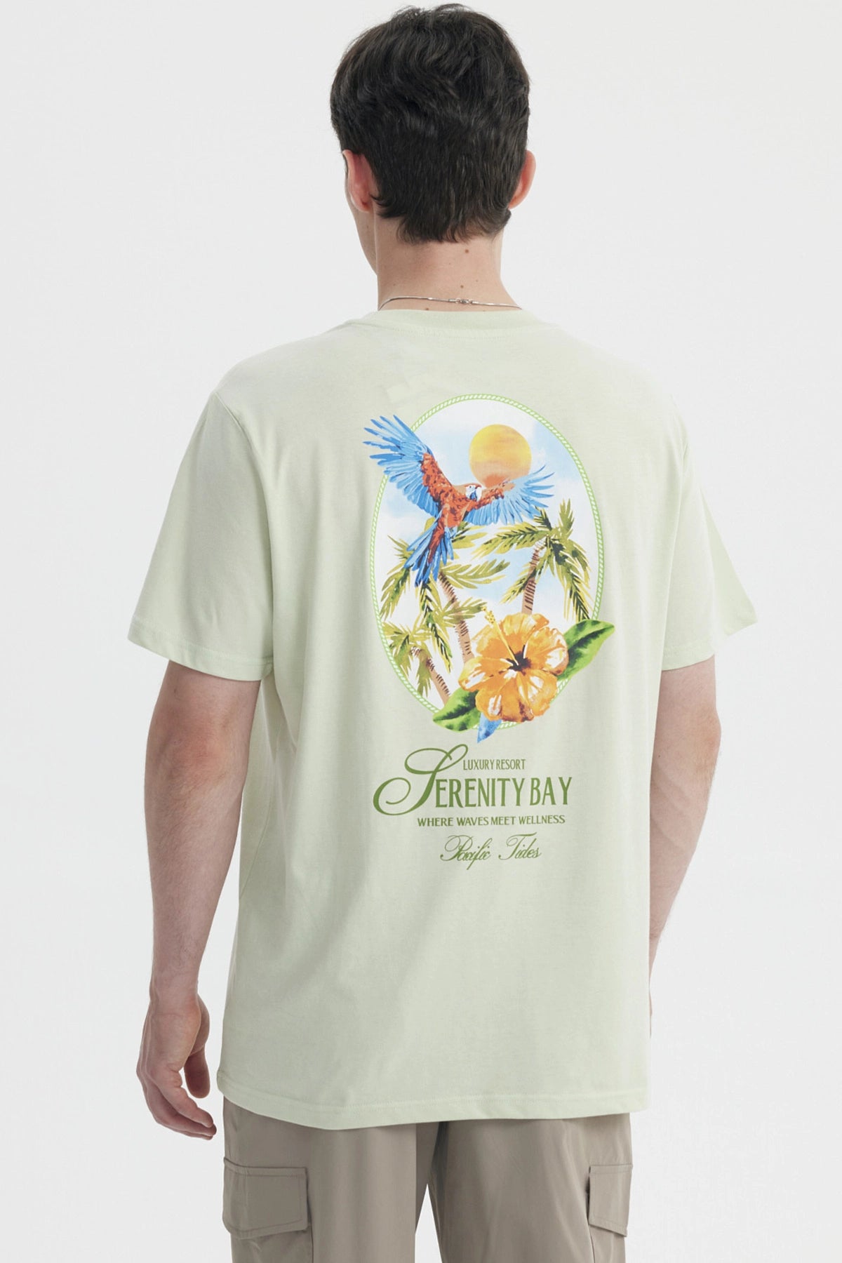 Polera oversize verde claro hombre con texto Serenity Bay en el pecho diseño minimalista y estilo casual relajado