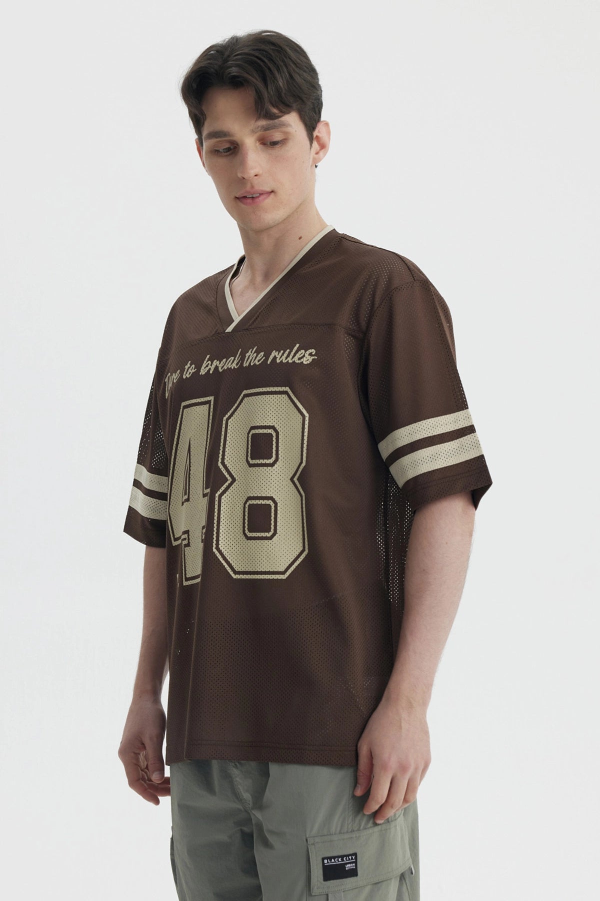 Polera oversize chocolate de hombre con texto Dare to break the rules y n
_x001B__x001B_mero 48 en el frente estilo deportivo
