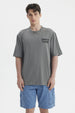 Polera gris para hombre con texto Summer's Flourish en el pecho estilo casual y corte relajado