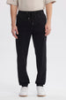 Pantalón jogger negro de hombre con cordón en la cintura diseño liso ajuste relajado y puños elásticos en tobillos