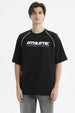 Polera negra oversize para hombre con estampado 'ATHLETIC' en el pecho estilo deportivo