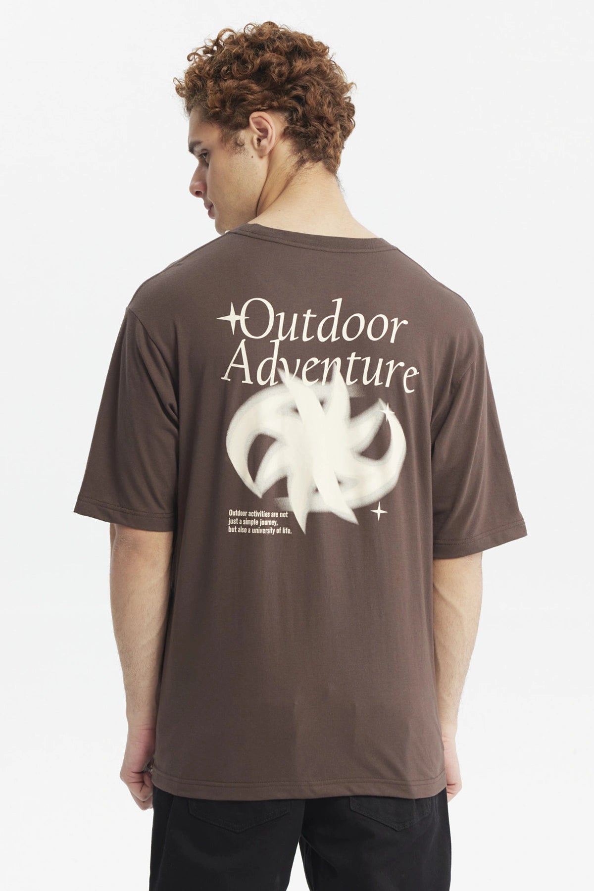 Polera oversize chocolate con estampado pequeño de media luna blanca en el pecho estilo minimalista