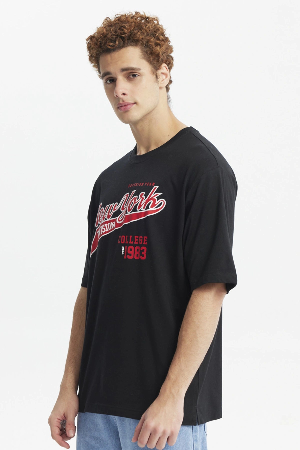 Polera negra juvenil con estampado New York Division en rojo y blanco estilo universitario al frente de tamaño mediano