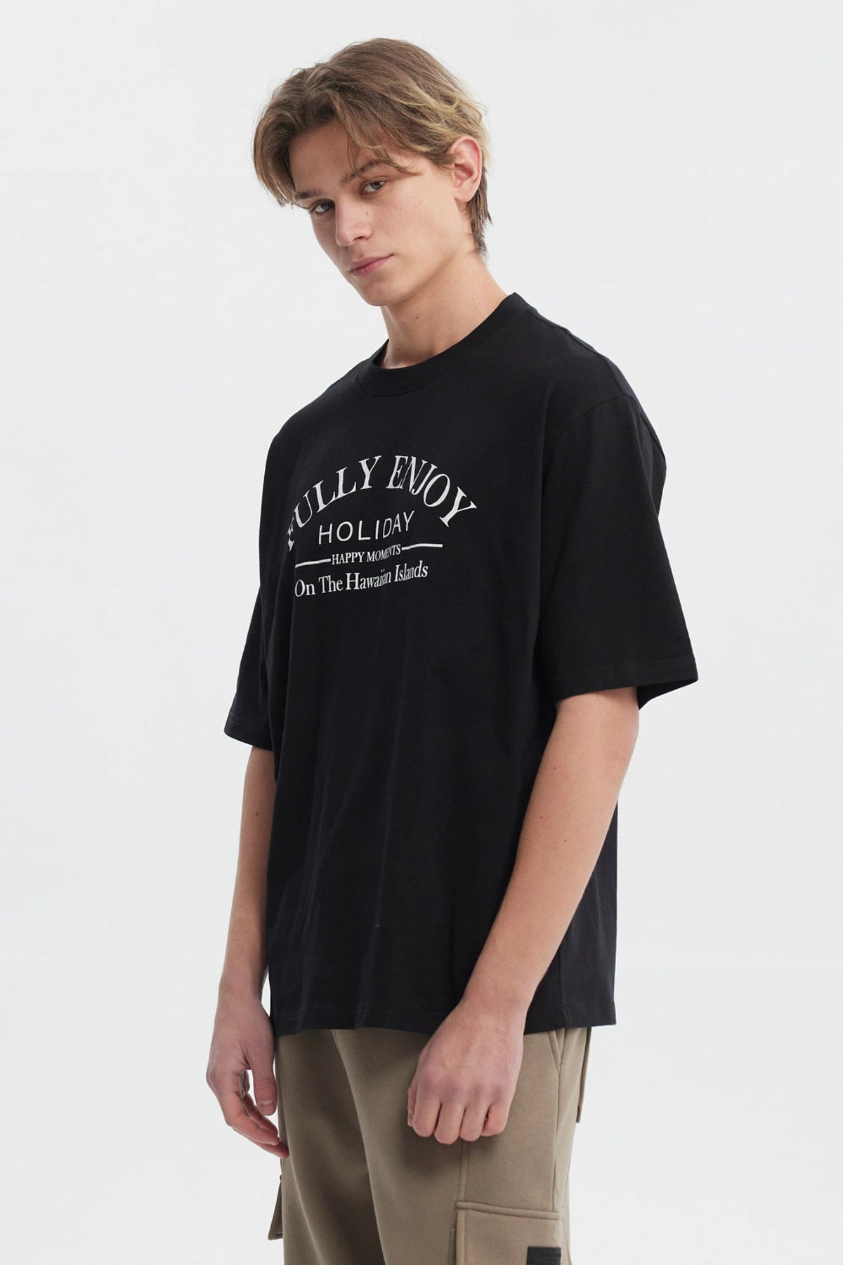 Polera negra slim para hombre con texto 'FULLY ENJOY HOLIDAY HAPPY MOMENTS On The Hawaiian Islands' en el frente
