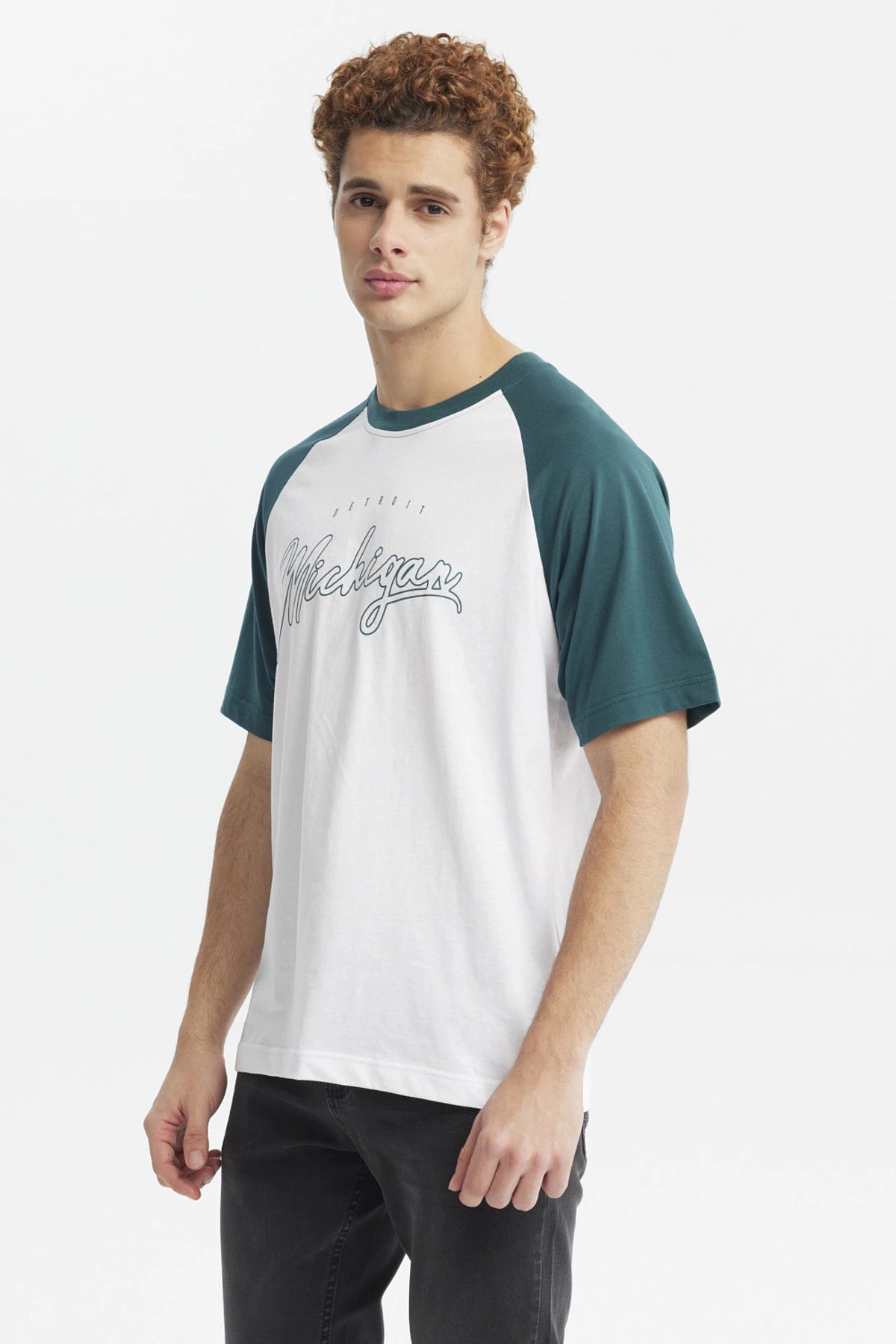 Polera slim verde con mangas raglán verde oscuro y cuerpo blanco diseño Michigan en el frente estilo deportivo casual
