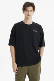 Polera negra slim para hombre con texto Freedom Trail en el pecho estilo minimalista casual y fondo blanco liso