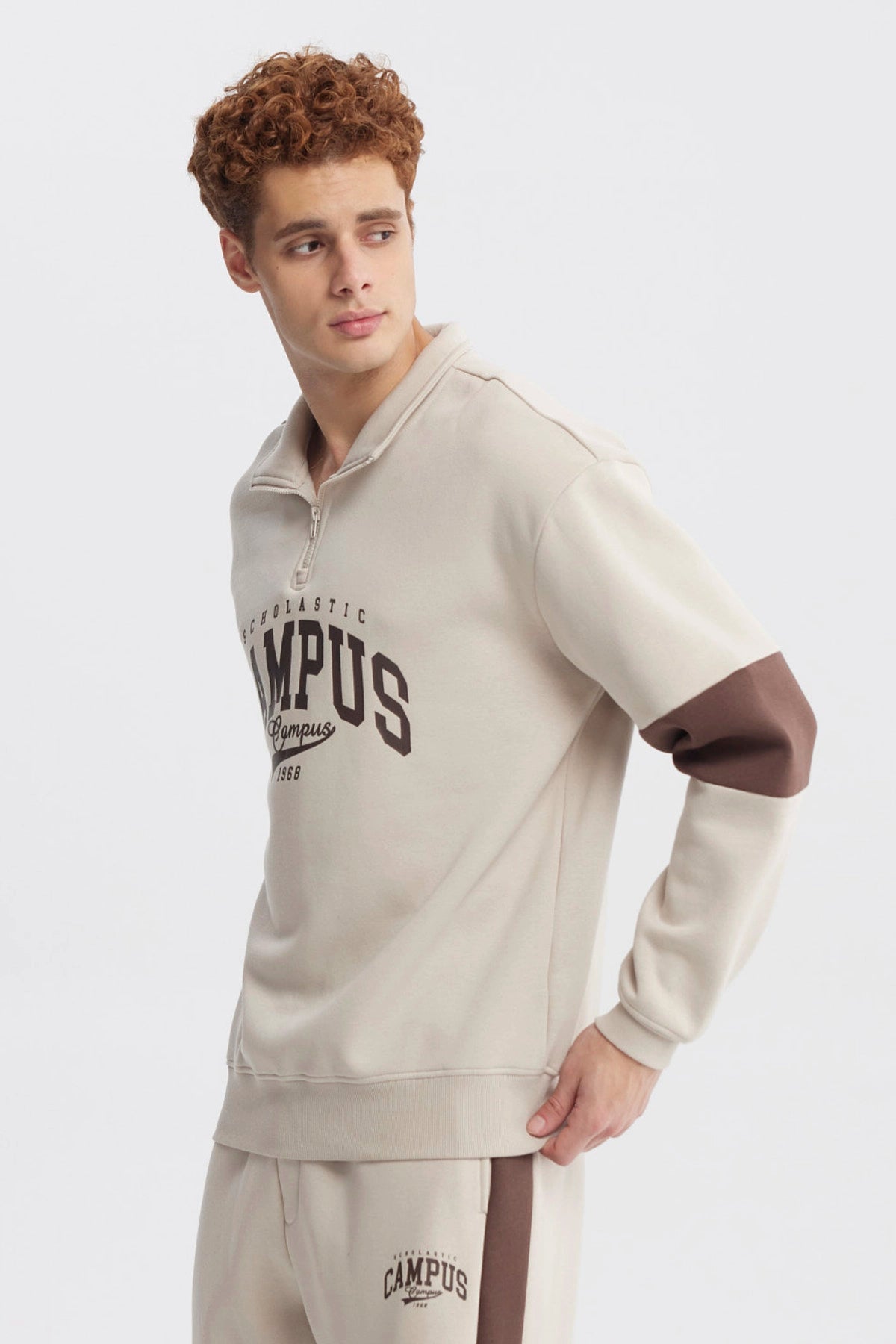 Polerón oversize beige con medio cierre y texto Campus 1968 en el pecho estilo universitario casual y cómodo